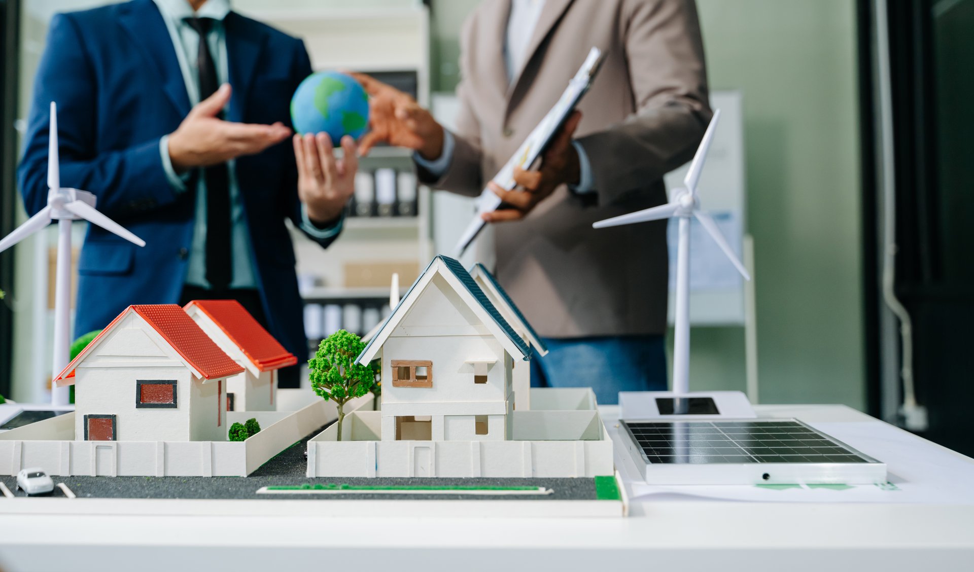 A professional team planning together over a laptop and printed documents, the lawyers who review and sign off on every output the assistant produces