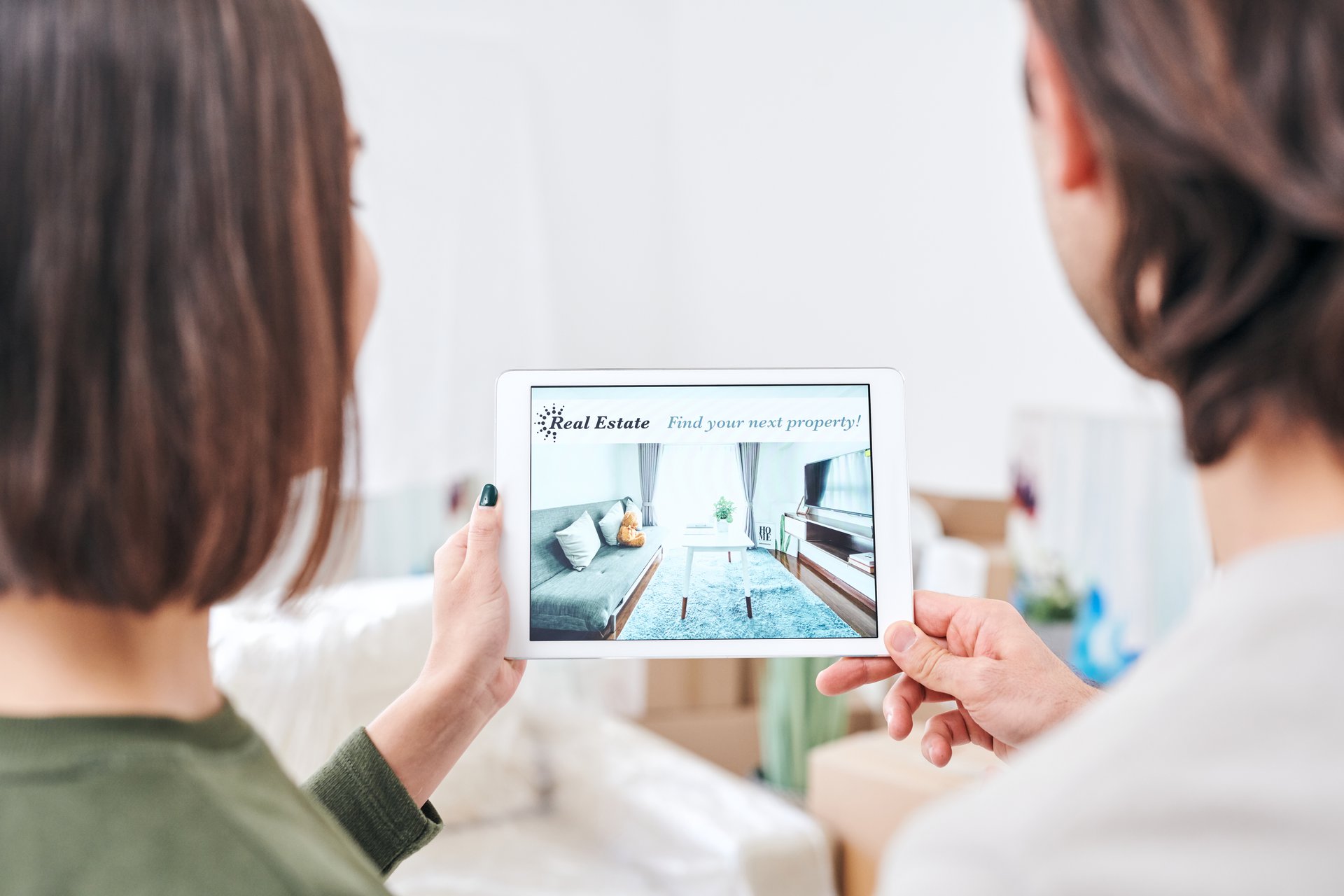 A young couple looking at a tablet together, the kind of personalised product recommendation a Databricks engine serves to the right shopper