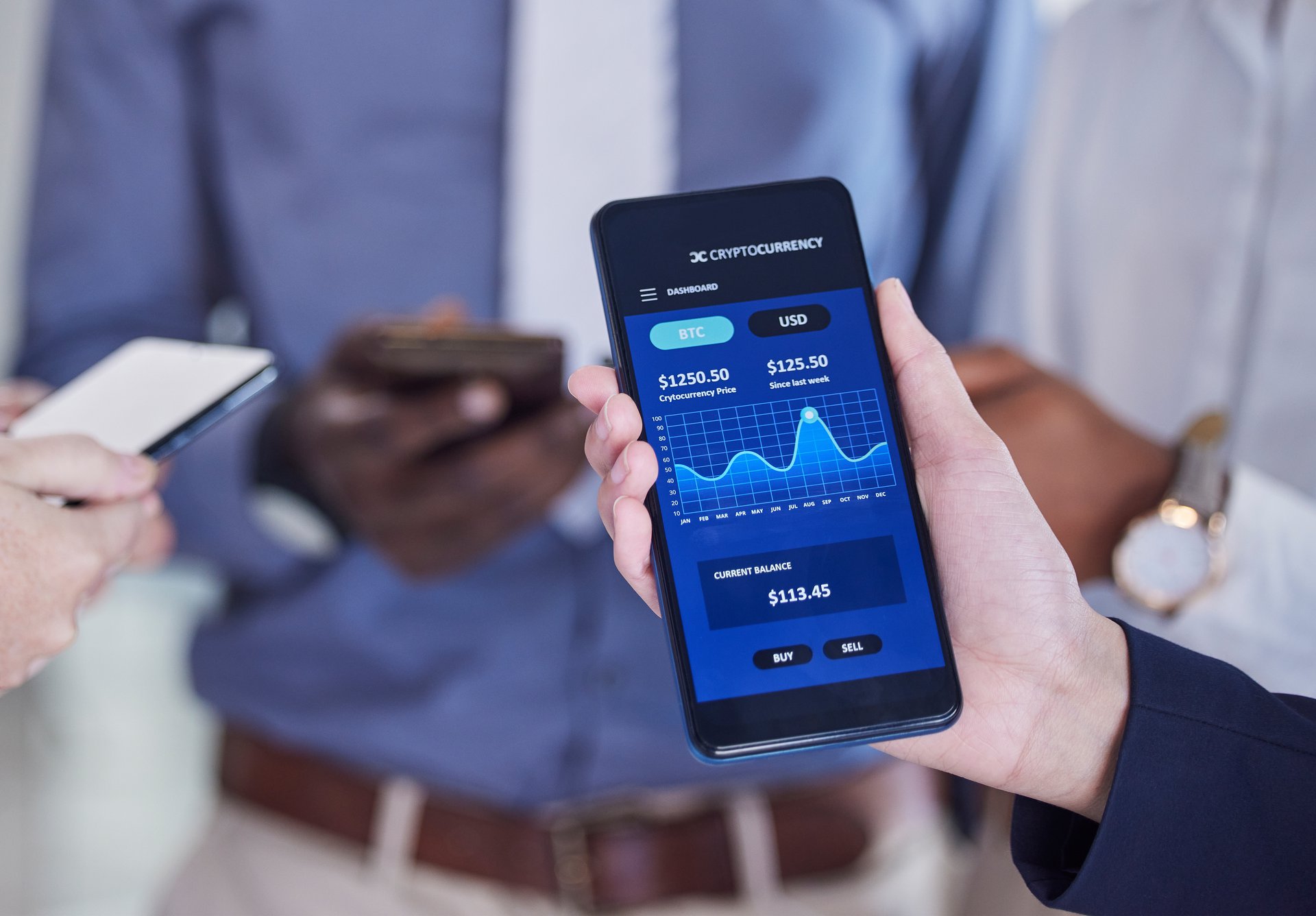 Hands reviewing financial claims statistics on a phone, the consistent view the platform puts in front of finance and actuarial teams